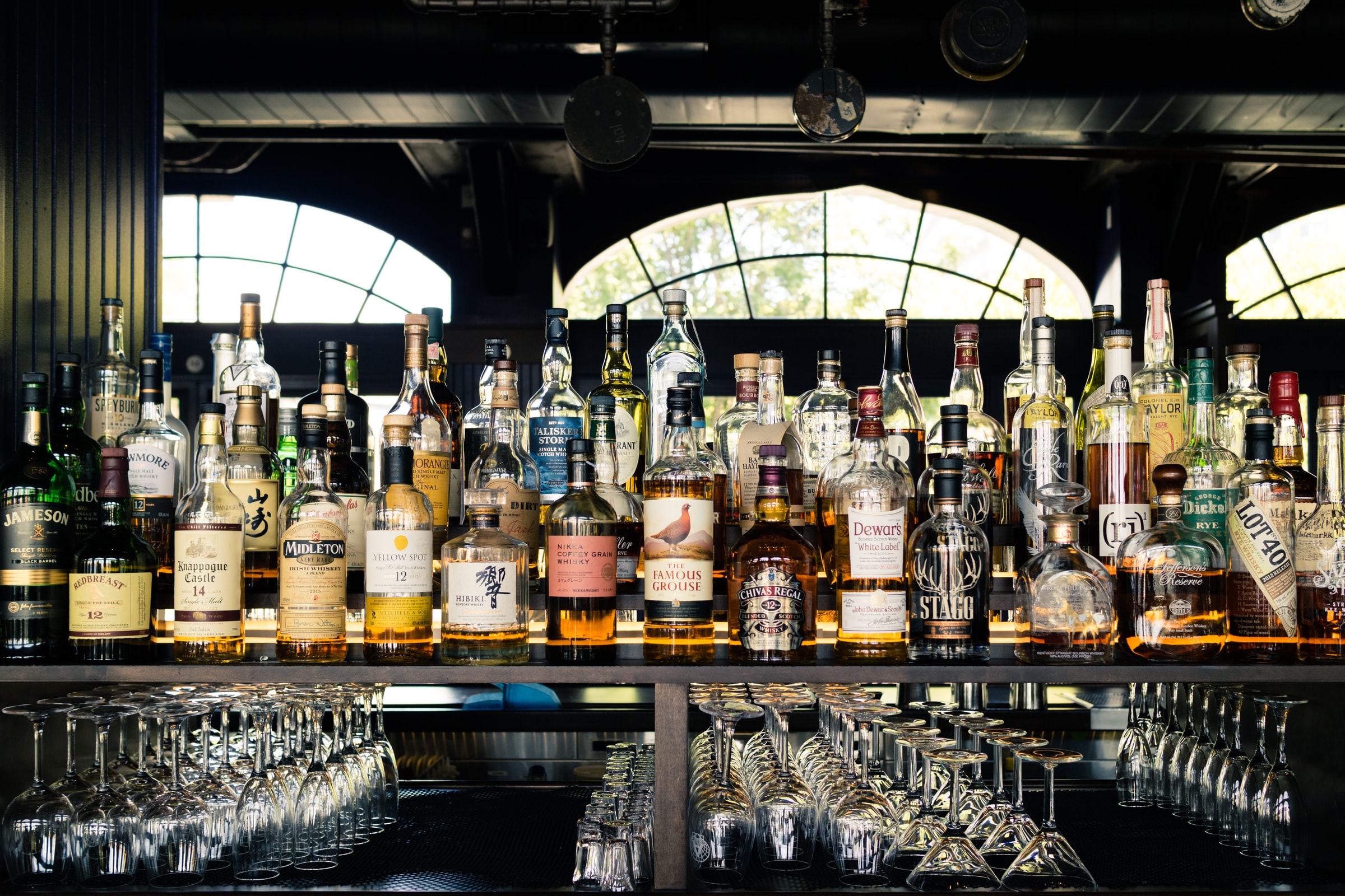 Rows of premium spirit bottles on a bar