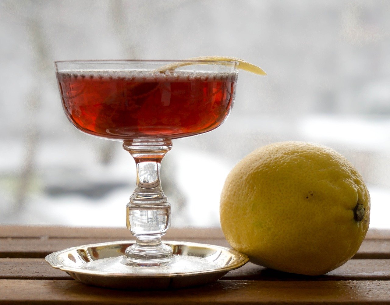 The Old Pal Cocktail, a twist on Classic Negroni Recipes, next to a lemon