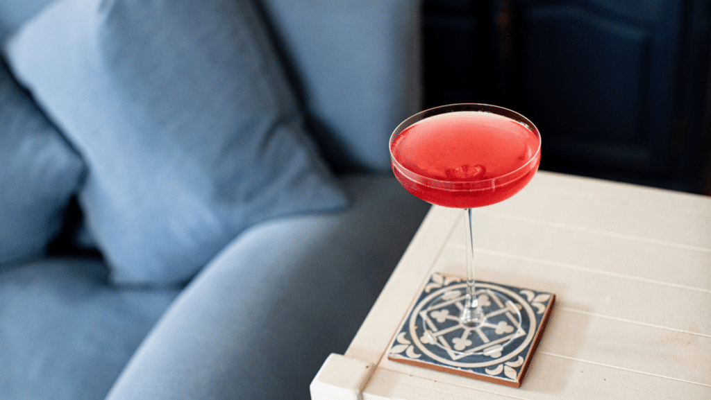 A Damp January cocktail - a rose red Cosmopolitan in a coupe cocktail glass