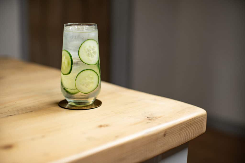 Gin and tonic with cucumber in a hi-ball glass, one of the easiest gin cocktail recipes