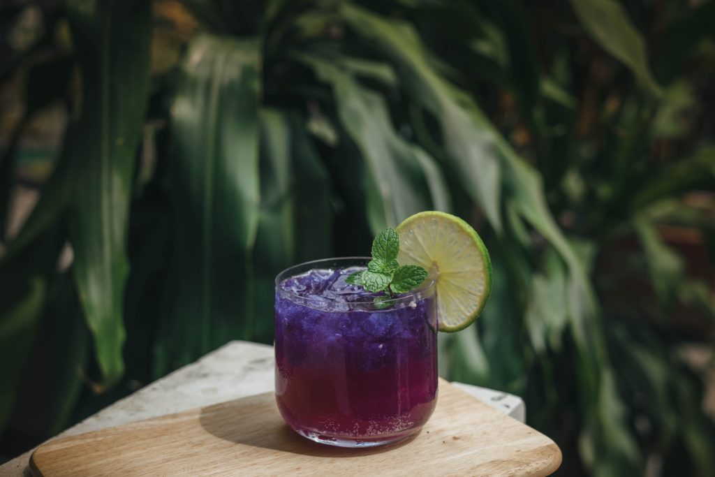 A purple cocktail in a rocks glass